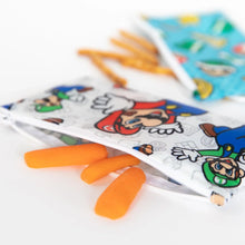 Load image into Gallery viewer, Close-up of Bumkins Reusable Snack Bag, Small 2-Pack: Super Mario™ on a white background with carrots and pretzels spilling out.