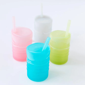 Four cups with straws, including Bumkins Silicone Straw Cup with Lid: Blue, sit on a white background.