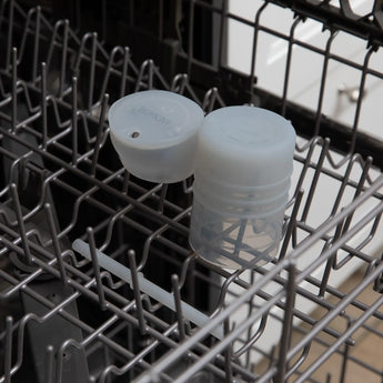 Bumkins Silicone Straw Cup with Lid: Gray sits in the top rack of an open dishwasher.