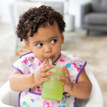 Load image into Gallery viewer, A toddler sips from a Bumkins Silicone Straw Cup with Lid: Sage, seated comfortably in a high chair.