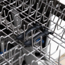 Load image into Gallery viewer, Bumkins Silicone Dipping Spoons: Mickey Mouse (Classic Black) sit on the top rack of an open dishwasher.