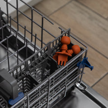 Load image into Gallery viewer, Bumkins Silicone Chewtensils®: Clay sits in the utensil compartment of an open dishwasher.