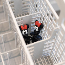 Load image into Gallery viewer, Bumkins Silicone Chewtensils: Minnie Mouse sits in the utensil compartment of an open dishwasher.