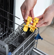 Load image into Gallery viewer, Hands place Bumkins Silicone Chewtensils®: Winnie The Pooh into the utensil compartment of an open dishwasher.