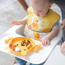 Load image into Gallery viewer, A baby in a high chair wearing a yellow bib enjoys breakfast from a bear plate with Bumkins Silicone Chewtensils®: Winnie The Pooh.