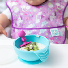Load image into Gallery viewer, Close-up of a blue bowl of yogurt and kiwi on a high chair tray with a Bumkins Silicone Chewtensils®: Fuchsia; a baby in a bib sits behind.