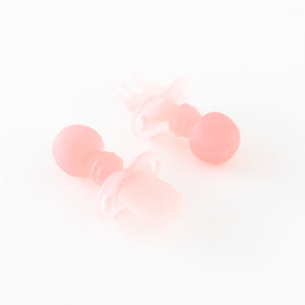Bumkins Silicone Chewtensils®: Pink Jelly are displayed on a white background with one face-down, showcasing sensory bumps on the back.