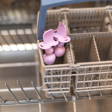 Load image into Gallery viewer, Bumkins Silicone Chewtensils®: Lavender sits in the utensil compartment of an open dishwasher.