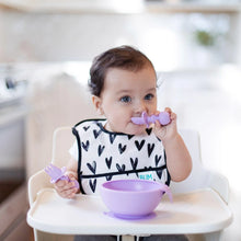 Load image into Gallery viewer, A toddler wearing a heart-patterned bib in a high chair eats from a purple bowl using Bumkins Silicone Chewtensils®: Lavender.