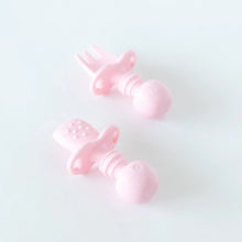 Load image into Gallery viewer, Bumkins Silicone Chewtensils®: Pink rest on a white background; one lays face down, displaying sensory bumps on the back.