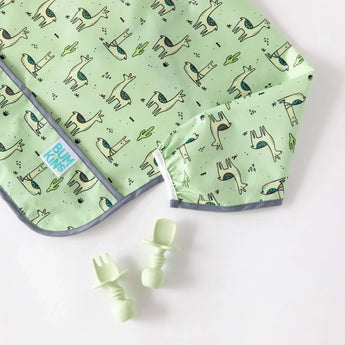 Bumkins Silicone Chewtensils®: Sage rest next to a green llama-patterned bib on a white background.