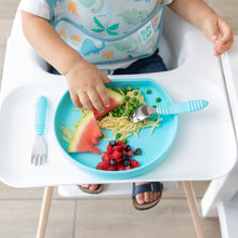 Load image into Gallery viewer, A child in a high chair enjoys eating spaghetti, peas, watermelon, and berries from a blue plate with Bumkins Spoon + Fork: Blue nearby.