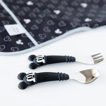 Load image into Gallery viewer, Close-up of Bumkins Spoon + Fork: Mickey Mouse on a white background in front of a black and white patterned bib.
