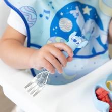Load image into Gallery viewer, Close-up of a child in a blue bib seated in a high chair, holding a fork from Bumkins Spoon + Fork: Stitch.