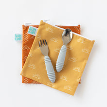 Load image into Gallery viewer, Bumkins Spoon + Fork: Gray sits on top of two stacked pouches in yellow and orange on a white background.
