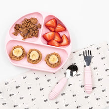 Load image into Gallery viewer, A pink plate with granola, strawberries, and bananas sits next to Bumkins Spoon + Fork: Pink on a patterned napkin on a white background.
