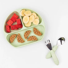 Load image into Gallery viewer, A divided round plate with watermelon, banana slices, and mini waffles sits beside Bumkins Spoon + Fork: Sage on a white background.