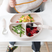 Load image into Gallery viewer, A toddler in a high chair uses Bumkins Spoon + Fork: Sand to eat green beans, berries, and rice with broccoli from a silicone divided plate.