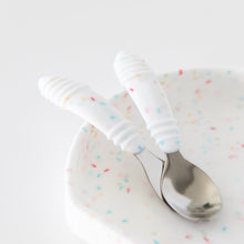 Load image into Gallery viewer, Close-up of Bumkins Spoon + Fork: Vanilla Sprinkle resting on a matching plate on a white background.