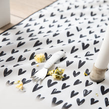 Load image into Gallery viewer, Close-up of a white baby fork with food bits on an easy-clean Bumkins Splat Mat: Hearts.