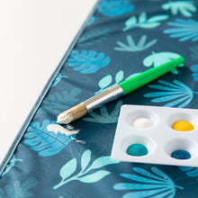 Load image into Gallery viewer, Close-up of Bumkins Splat Mat: Blue Tropic on a white background with a paint palette and green paintbrush on top.