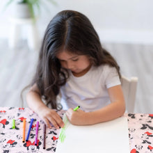 Load image into Gallery viewer, A girl draws with markers on paper at a table covered by Bumkins Splat Mat: Minnie Mouse.