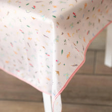 Load image into Gallery viewer, Close-up of Bumkins Splat Mat: Princess Magic covering a table on a wood floor.