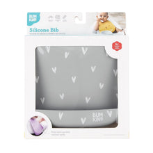 Load image into Gallery viewer, Bumkins Silicone Bib: Hearts is shown in a white packaging box with a clear front window displaying the bib.