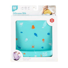 Load image into Gallery viewer, Bumkins Silicone Bib: Ocean Life is shown in a white packaging box with a clear front window displaying the bib.
