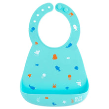 Load image into Gallery viewer, Bumkins Silicone Bib: Ocean Life is made of blue silicone and adorned with sea creatures like jellyfish and whales.