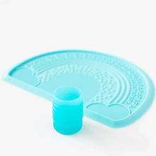 Load image into Gallery viewer, Bumkins Silicone Starter Cup: Blue sits in front of a blue placemat on a white background.