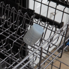 Load image into Gallery viewer, Bumkins Silicone Starter Cup: Gray sits in the top rack of an open dishwasher.