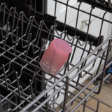 Bumkins Silicone Starter Cup: Pink sits in the top rack of an open dishwasher.
