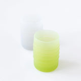 Bumkins Silicone Starter Cup: Sage sits in front of a gray cup on a white background.