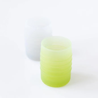 Bumkins Silicone Starter Cup: Sage sits in front of a gray cup on a white background.