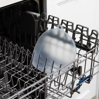 Bumkins Silicone Stretch Lid for Grip Dish 3 Section, Grip Plate sits in the top rack of an open dishwasher.