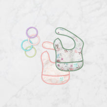 Load image into Gallery viewer, Bumkins Starter Bib 2 Pack: Floral & Lace lays overlapped on a marble background with 4 pastel teething rings nearby.
