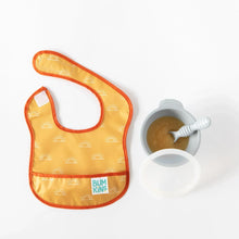 Load image into Gallery viewer, A Bumkins Starter Bib 2 Pack: Sunshine and Grounded lays on a white background next to a gray bowl of applesauce, spoon, and lid.