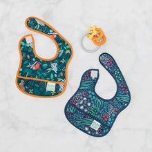 Load image into Gallery viewer, Bumkins Silicone Teething Charms: Orange lays next to two jungle-themed bibs on a white background.