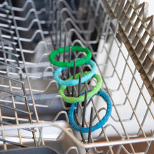 Load image into Gallery viewer, Bumkins Silicone Teething Rings 4 Pack: Summer sits in the top rack of an open dishwasher.