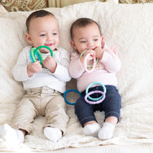 Load image into Gallery viewer, Two babies sit on a plush, cream-colored blanket with teething rings, including Bumkins Silicone Teething Rings 4 Pack: Spring.