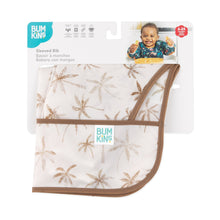 Load image into Gallery viewer, Bumkins Sleeved Bib: Palm Daze is shown folded in its packaging.