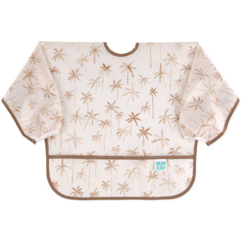 Bumkins Sleeved Bib: Palm Daze features waterproof fabric, a light brown palm tree pattern, and a pocket—ideal for baby-led weaning.