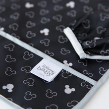 Load image into Gallery viewer, Close-up of Bumkins Sleeved Bib: Mickey Mouse Icon Black + White on a white background, with focus on the front pocket and elastic cuff.