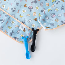 Load image into Gallery viewer, Two baby spoons, blue and black, sit beside a Bumkins Sleeved Bib: Mickey + Minnie Sunny Side Up on a white background.