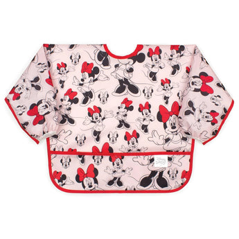 Bumkins Sleeved Bib: Minnie Mouse is made of pink waterproof fabric with a Minnie Mouse design, red trim, and front pocket.