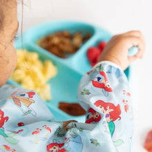 Load image into Gallery viewer, Close-up of a child enjoying snacks from a blue plate with a fork, wearing Bumkins Sleeved Bib: Ariel.