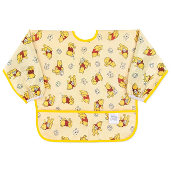 Bumkins Sleeved Bib: Winnie Loves Hunny features yellow waterproof fabric with playful Winnie the Pooh illustrations and a front pocket.