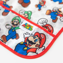 Load image into Gallery viewer, Close-up of Bumkins Sleeved Bib: Super Mario™ Classic on a white background, with focus on the front pocket.