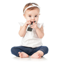 Load image into Gallery viewer, A baby on a white background chews a Bumkins Silicone Teether: NES™ Controller.